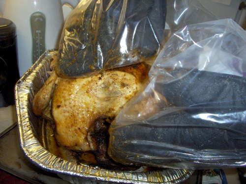 2006's turkey getting a flip with ziptop bags over oven mitts. 