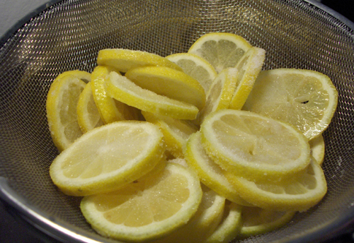 Lemons coated generously in salt, draining